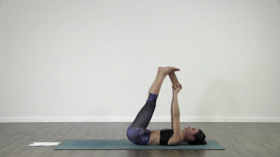 Yogi is practising yoga on a blue yoga mat on white background