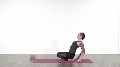Yoga teacher performing yoga posture on green yoga mat on white background