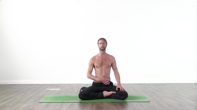 Yoga teacher performing yoga posture on green yoga mat on white background