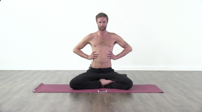 Yogi is practising yoga on a burgundy coloured yoga mat on white background