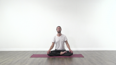 Yogi is practising yoga on a blue yoga mat on white background