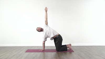 Yogi is practising yoga on a blue yoga mat on white background