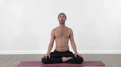 Yogi is practising yoga on a blue yoga mat on white background