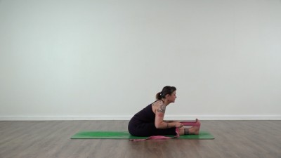 Yoga teacher performing yoga posture on green yoga mat on white background