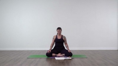 Yoga teacher performing yoga posture on green yoga mat on white background