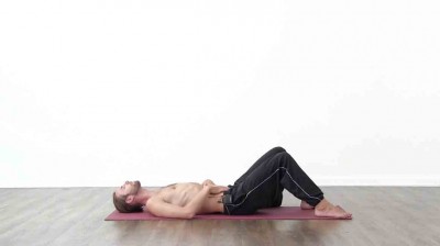 Yogi is practising yoga on a blue yoga mat on white background